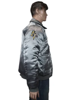 Battletech Mechwarrior embroidered bomber jacket, silver satin, left side view with a yellow shoulder logo on a mannequin.