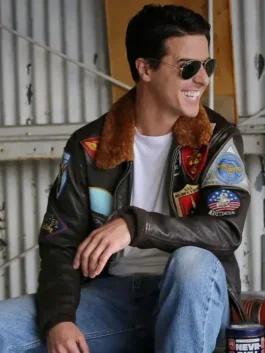 Tom Cruise wearing a top gun maverick jacket with aviator sunglasses, showcasing the stylish fit and detailed embroidery of this iconic bomber jacket.