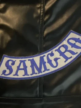 Close-up of the SAMCRO blue and white patch stitched onto a black leather sons of anarchy vests. soa vest