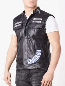 Side view of a man wearing a vest sons of anarchy cut. Shows President, Redwood Original, and SAMCRO patches. soa vest