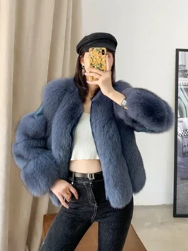 Stylish women wearing a luxury fur shoulder crop jacket featuring a voluminous textured design and a contemporary cropped silhouette.