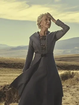 Helen Mirren as Cara Dutton in the series 1923 wearing a long grey period-style wool coat.
