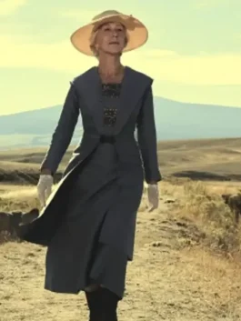 Helen Mirren wearing the elegant grey 1923 Cara Dutton Coat in a rural field