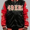 Black and red varsity jacket with embroidered championship patches on sleeves