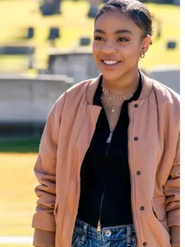 Priah Ferguson as Sydney Gordon wearing a quilted peach bomber jacket in a scene from The Curse of Bridge Hollow movie.