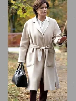 Marcia Gay Harden So Help Me Todd Margaret Beige Wrap Coat featuring a sophisticated waist tie and wide lapels.