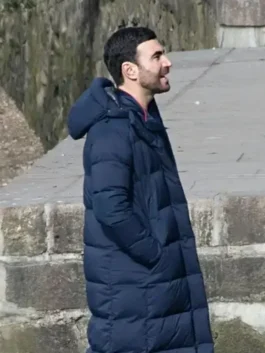 Side profile of the Brett Goldstein Ted Lasso S03 Roy Kent Blue Hooded Puffer Coat showing the thick quilted puffer design and integrated hood.