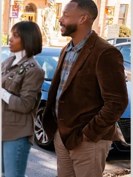 A man wearing the Howard Gordon blazer from The Curse of Bridge Hollow over a plaid shirt.