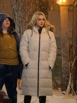 Paris Berelc as Vivian Lee in a long off-white hooded puffer coat standing outside during a winter snowfall