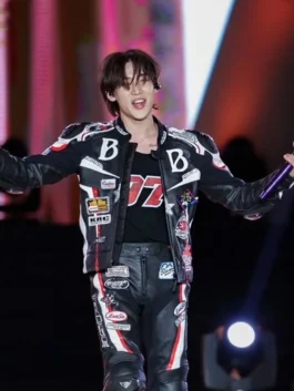 Men's black leather biker jacket with vibrant white and red racing patches and slogans.