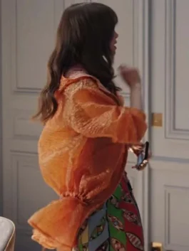 Fashionable bright orange rain-style jacket featuring a large hood and drawstring details.