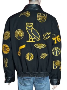 Premium athletic jacket featuring all-over gold team logo patches.