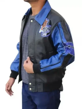 Side profile of a scooby doo bomber jacket showing blue leather sleeves with patches and a classic scooby doo varsity jacket silhouette.
