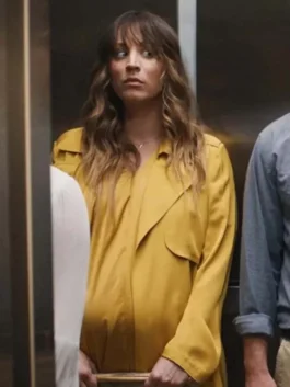 Kaley Cuoco as Ava Bartlett in Based on a True Story wearing a bright yellow trench coat.