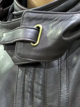A Kansas City Chiefs Black Bomber Jacket displayed on a wooden hanger against a white background.