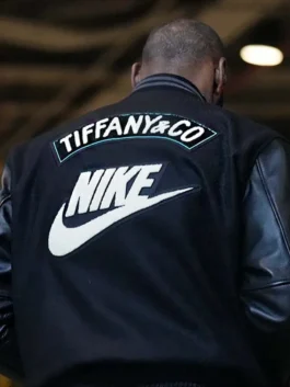 Close-up of LeBron James wearing the black Tiffany and Co Nike jacket, showing the "TIFFANY & CO" in turquoise and large white "NIKE" swoosh logo on the back. This is a highly sought-after Tiffany Nike jacket.