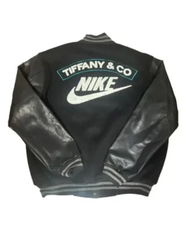 Full-body flat lay of a black and leather Tiffany and Co Nike jacket (varsity style). The back features 