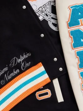 Premium wool-blend letterman jacket with cream-colored sleeves and snap-button closure.