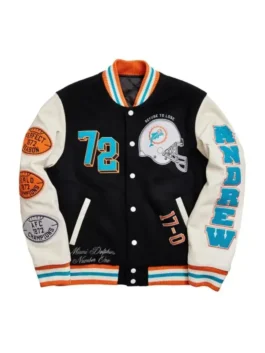 Men's black and cream varsity jacket with sports-themed patches and teal accents.