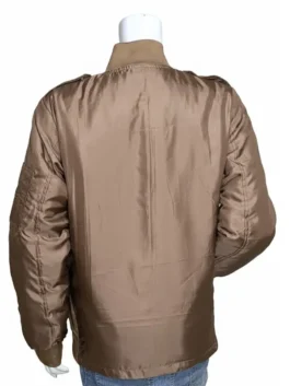 Jennifer Connelly wearing the Penny Benjamin brown bomber jacket from Top Gun Maverick, featuring a flight-style design and ribbed cuffs.