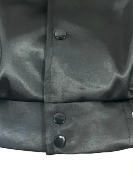 A close-up of the embroidered black patches on the gold LA Dodgers jacket at America Jackets.