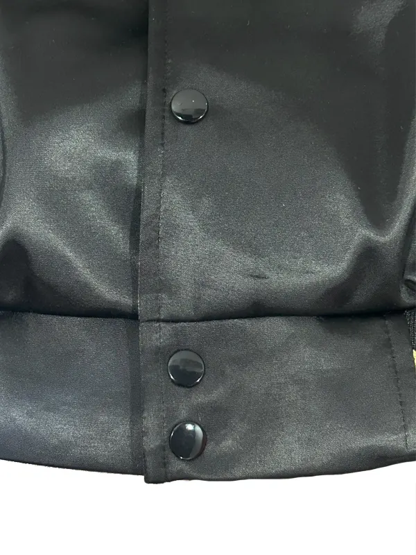 A close-up of the embroidered black patches on the gold LA Dodgers jacket at America Jackets.