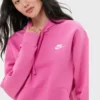 Close-up of a model wearing a bright hot pink Nike hoodie for women. Perfect ladies pink Nike hoodie style, showcasing the white Nike logo.