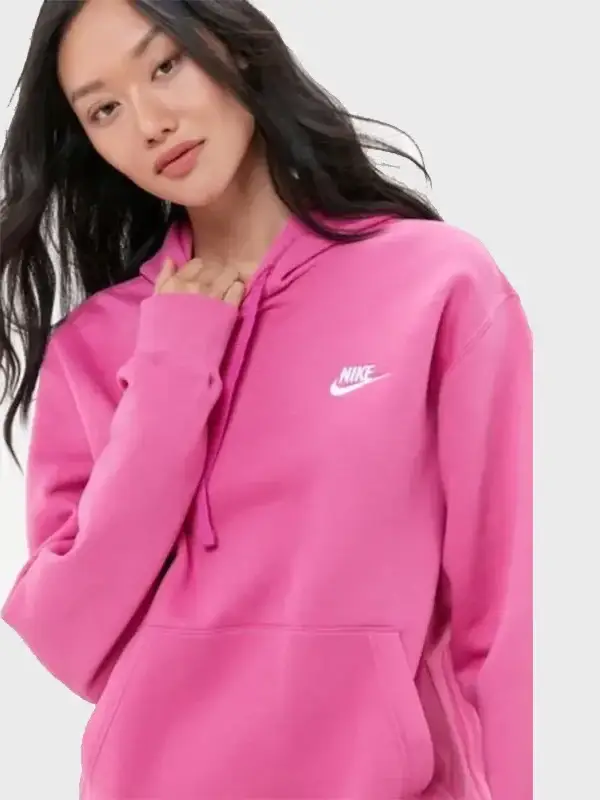 Close-up of a model wearing a bright hot pink Nike hoodie for women. Perfect ladies pink Nike hoodie style, showcasing the white Nike logo.