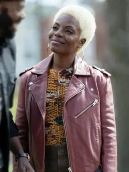 Elena Powell (played by Marsha Stephanie Blake) in The Madness 2024 wearing a mauve asymmetrical leather biker jacket with gold hoop earrings.
