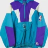 Close-up image of a Charlotte Hornets Starter jacket pullover. This vintage Charlotte Hornets Starter jacket highlights the teal, purple, and white color-block design, the front pouch with the embroidered logo, and the NBA and Starter jackets Hornets logos.