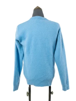 Rear view of the pastel blue fuzzy knit crewneck sweater highlighting its clean tailoring and tactile finish.