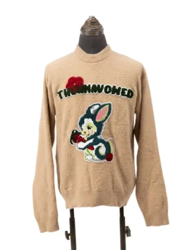 Front view of a camel brown fuzzy knit crewneck sweater embellished with a green arched logotype patch and a vintage cartoon rabbit illustration.