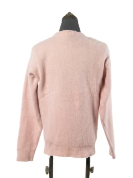Rear view of the light pink fuzzy knit crewneck sweater showcasing its minimalist style and ribbed hemline detailing.