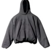 Front view of yeezy gap black hoodie with oversized fit, kangaroo pocket and faded GAP logo.