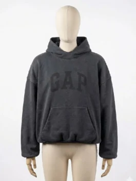 Front view of yeezy gap black hoodie on mannequin, featuring faded GAP logo and kangaroo pocket.