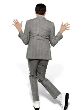 Back view of Pee Wee Herman in his classic grey pee wee herman costume with white shoes, striking a playful pose.