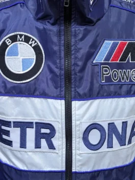 Close-up detail of a BMW Petronas F1 Racing Jacket highlighting the embroidered BMW logo, M Power patch, and Petronas branding across the chest.