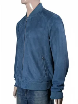 Brad Pitt wearing a stylish navy blue bomber leather jacket with a checkered lining on the set of his F1 racing film.