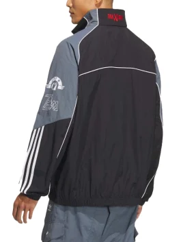Rear view of black and gray Adidas Adicolor Motorcore Woven Jacket with red Traxion collar detail