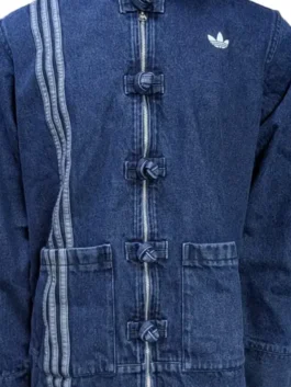 Close-up of the blue denim fabric and colorful embroidery on the Adidas jacket at America Jackets.