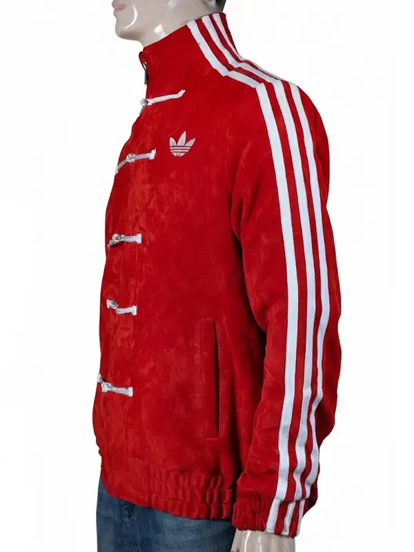 A woman wearing a red Adidas Chinese New Year jacket featuring white traditional toggle closures and the iconic three-stripes on the sleeves.