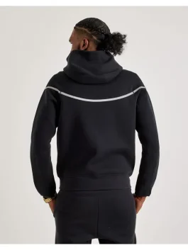 Back view of black reflective Nike Tech fleece tracksuit showing reflective stripe and hood design for men.