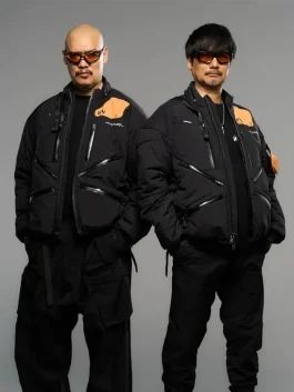 Front view of Death Stranding 2 jacket featuring black and orange design with modern zippers.