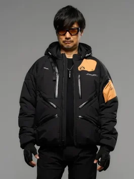 Front view of Hideo Kojima's Death Stranding 2 black jacket with modern design and orange accents.