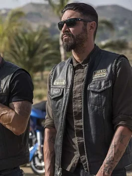 Mayans M.C Angel Reyes Leather Vest worn by Clayton Cardenas, front view with club patches and sunglasses.