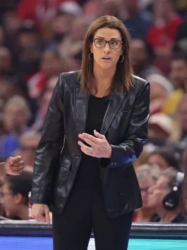 Stephanie White talking courtside in leather jacket.