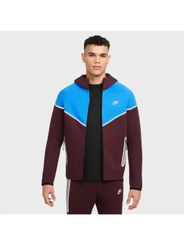 Front side of burgundy New Nike Tech Reflective Windrunner tracksuit with blue detailing and reflective zip pockets.