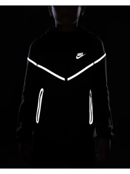 Black Nike Tech reflective jacket glowing in low light, showcasing reflective Nike Tech fleece design for men.