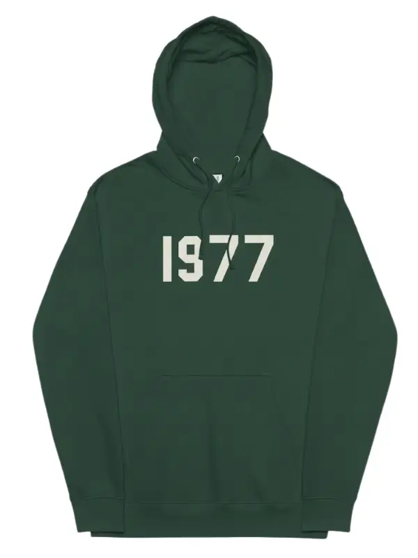 A dark green Fear of God Essentials hoodie with the large numbers "1977" printed in a contrasting light color on the chest.