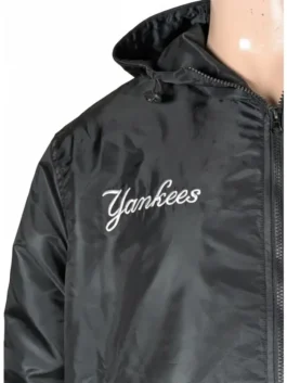 A black hooded New York Yankees bomber jacket featuring collaborative branding from Alpha Industries and New Era.